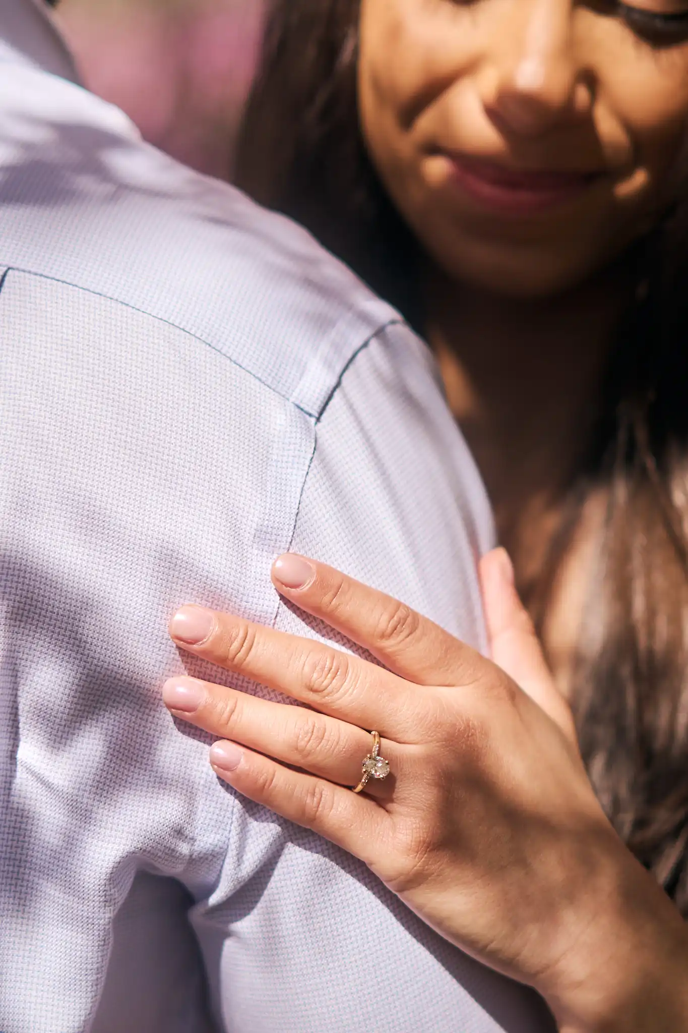 Holding arm with ring on her hand